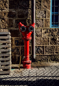 Red fire hydrant against building