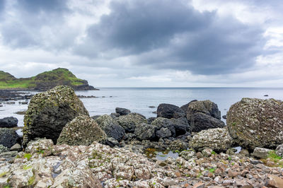 Rocks on beach against sky