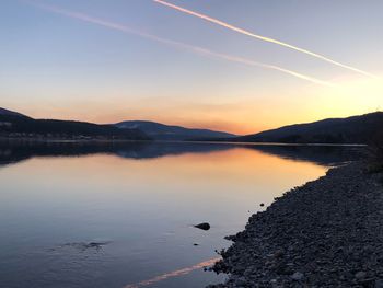 Scenic view of lake against sky during sunset