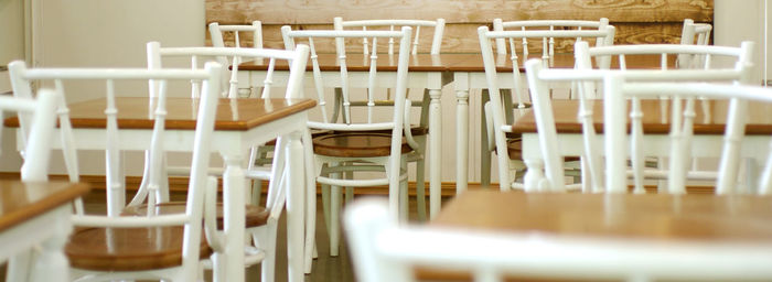 Empty chairs in cafe coffee shop wood and white 