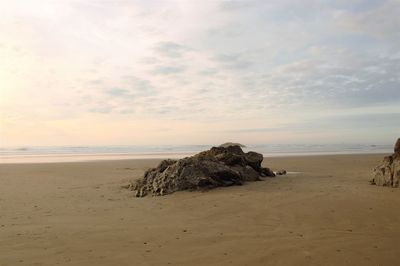 Scenic view of beach against sky during sunset