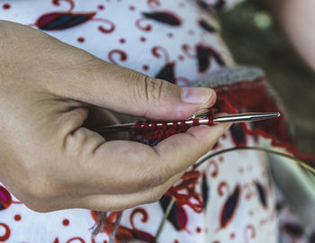 Midsection of woman knitting wool