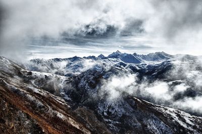 Scenic view of mountains against cloudy sky