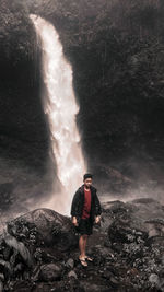 Full length of man standing on rock