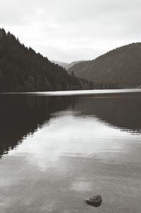 Scenic view of calm lake against mountain range