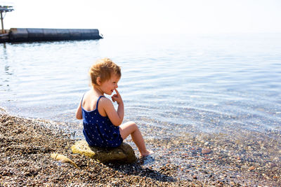 High angle view of woman sitting on beach