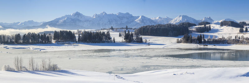 Scenic view of snow covered landscape against sky