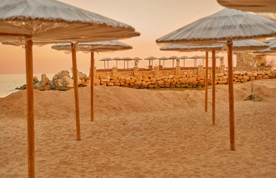 Straw umbrellas from the sun on a deserted beach.