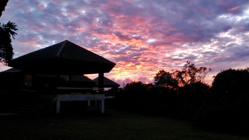 Silhouette built structure against sky during sunset