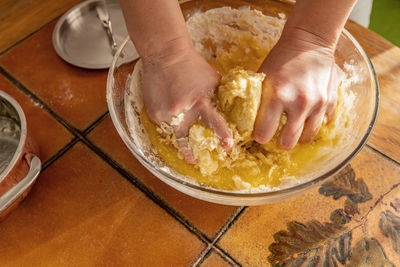 Midsection of person preparing food in kitchen