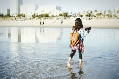 Full length of woman standing in water