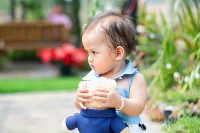 Cute baby girl holding ice cream