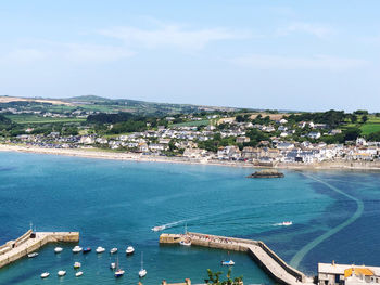 High angle view of cityscape by sea against sky