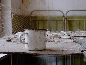 Close-up of old rusty glass on table