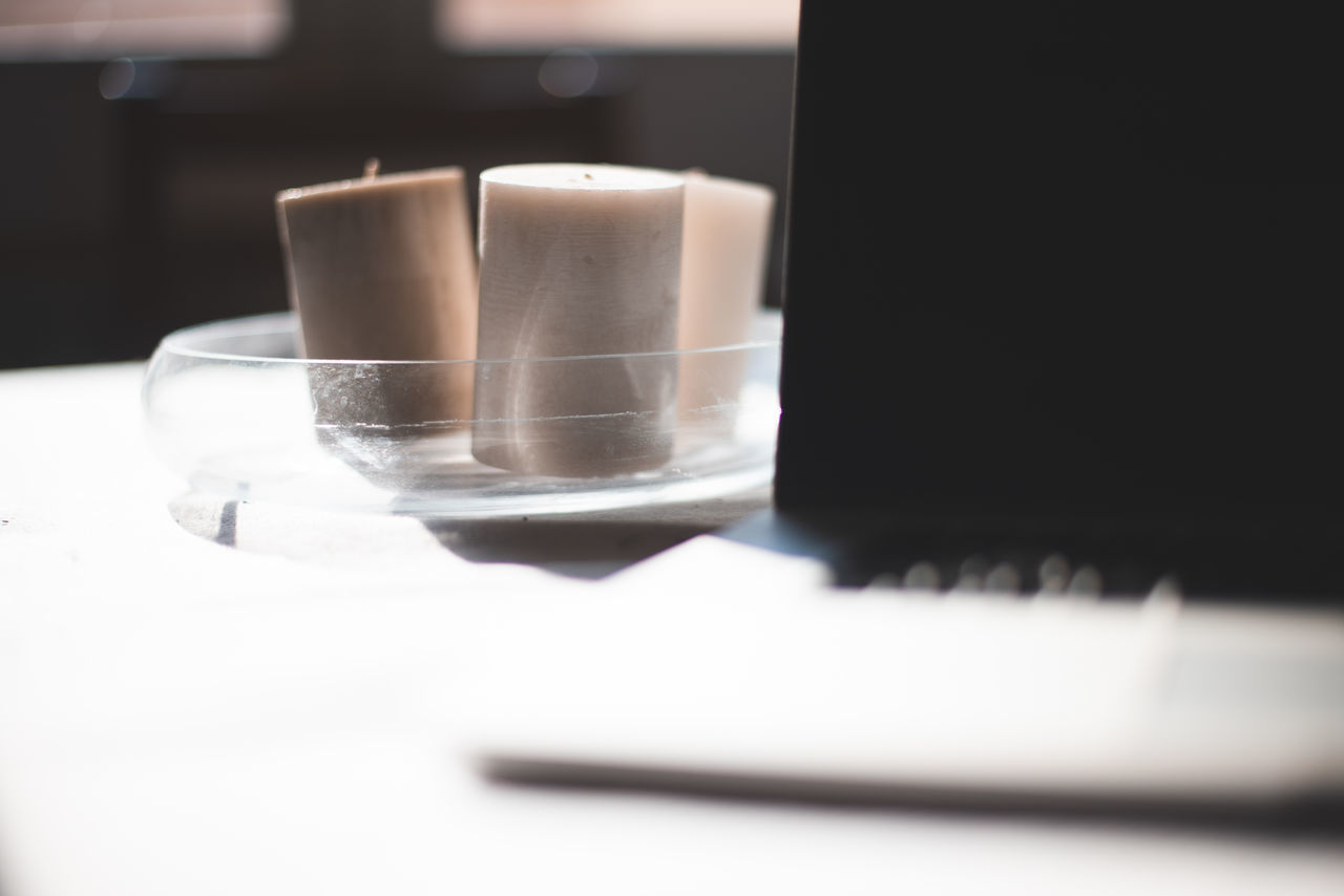 CLOSE-UP OF COFFEE CUP ON TABLE WITH TEXT