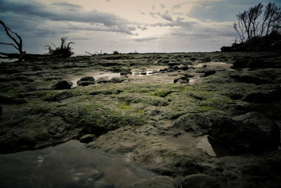 Scenic view of rocks on landscape against sky