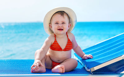 Portrait of young woman swimming in pool