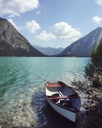 Boat in lake against sky