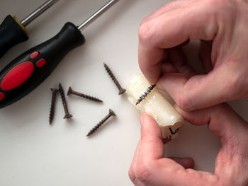 Cropped hand of man working on table