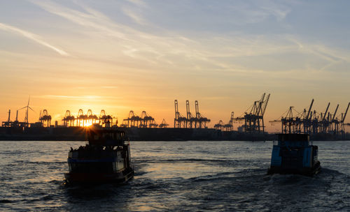 Commercial dock against sky during sunset