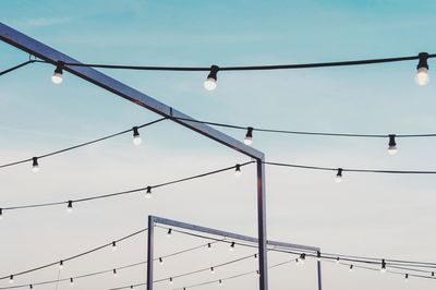 Low angle view of light bulbs against sky