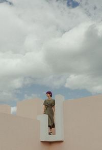 Full length of man standing in box against sky