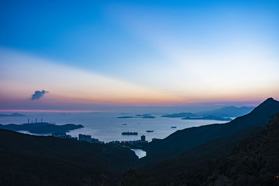 Scenic view of silhouette mountains against sky at sunset