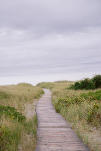 Rear view of woman walking on field