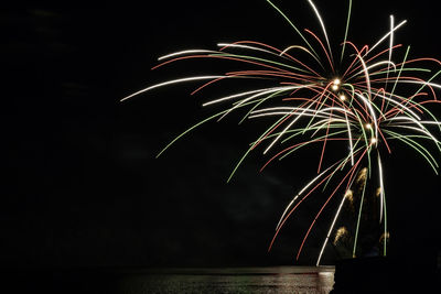 Low angle view of firework display at night