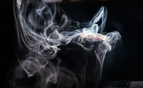 Close-up of smoke against black background