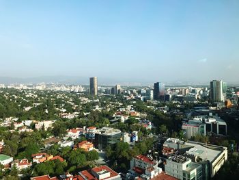 High angle view of buildings in city against clear sky