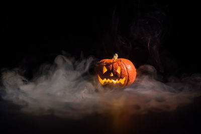 Close-up of illuminated fire against black background