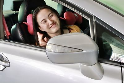 Portrait of woman sitting in car
