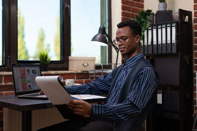 Businessman reading document in office