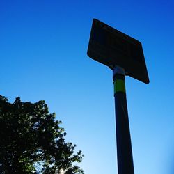 Low angle view of tree against blue sky