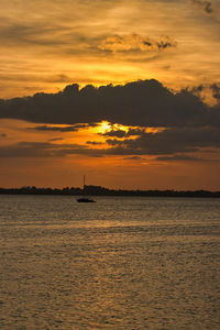 Scenic view of sea against orange sky