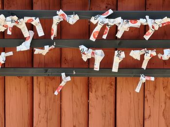 Clothes drying on clothesline against orange wall