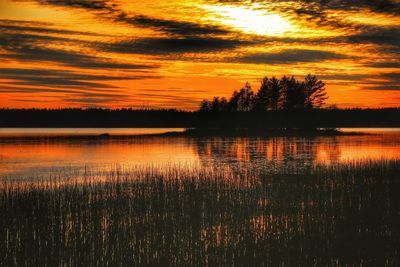 Scenic view of lake against romantic sky at sunset