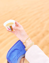 Cropped hand of woman holding teacup