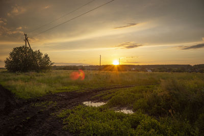 Scenic view of field against sky during sunset