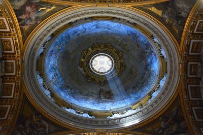 Directly below shot of illuminated ceiling in historic building