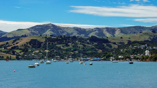 Scenic view of sea and mountains against sky