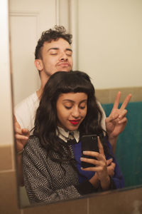 Young couple posing for selfies in their bathroom
