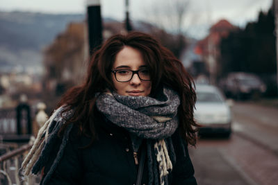 Portrait of beautiful woman in city during winter