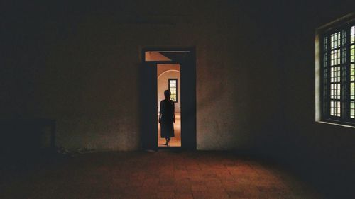 Woman standing by door in building