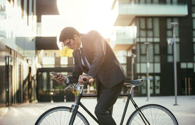 Man riding bicycle on street in city