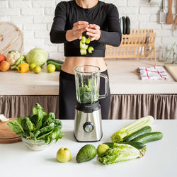 Midsection of woman preparing food in kitchen