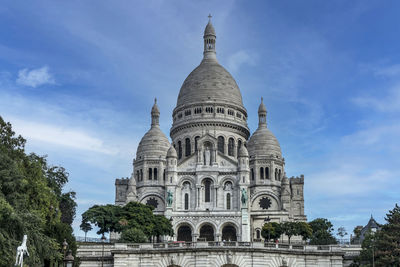 The sacre coeur basilica of montmartre in paris with blue sky and clouds