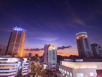 Low angle view of skyscrapers lit up at night