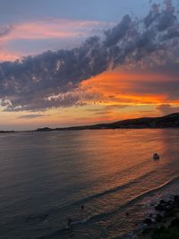 Scenic view of sea against romantic sky at sunset